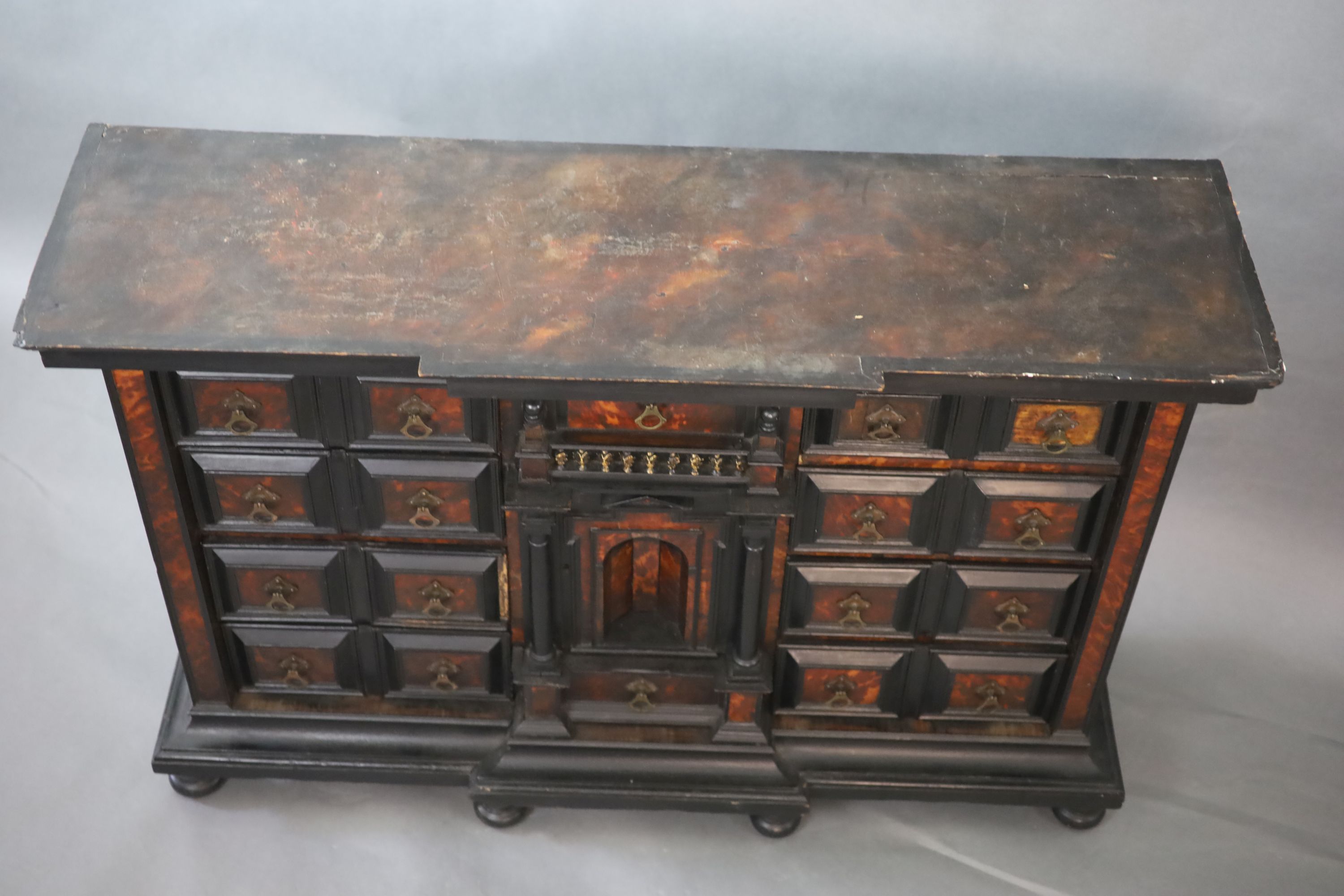 A late 17th century Portuguese ebony and tortoiseshell table cabinet, W.128cm D.39cm H.85cm